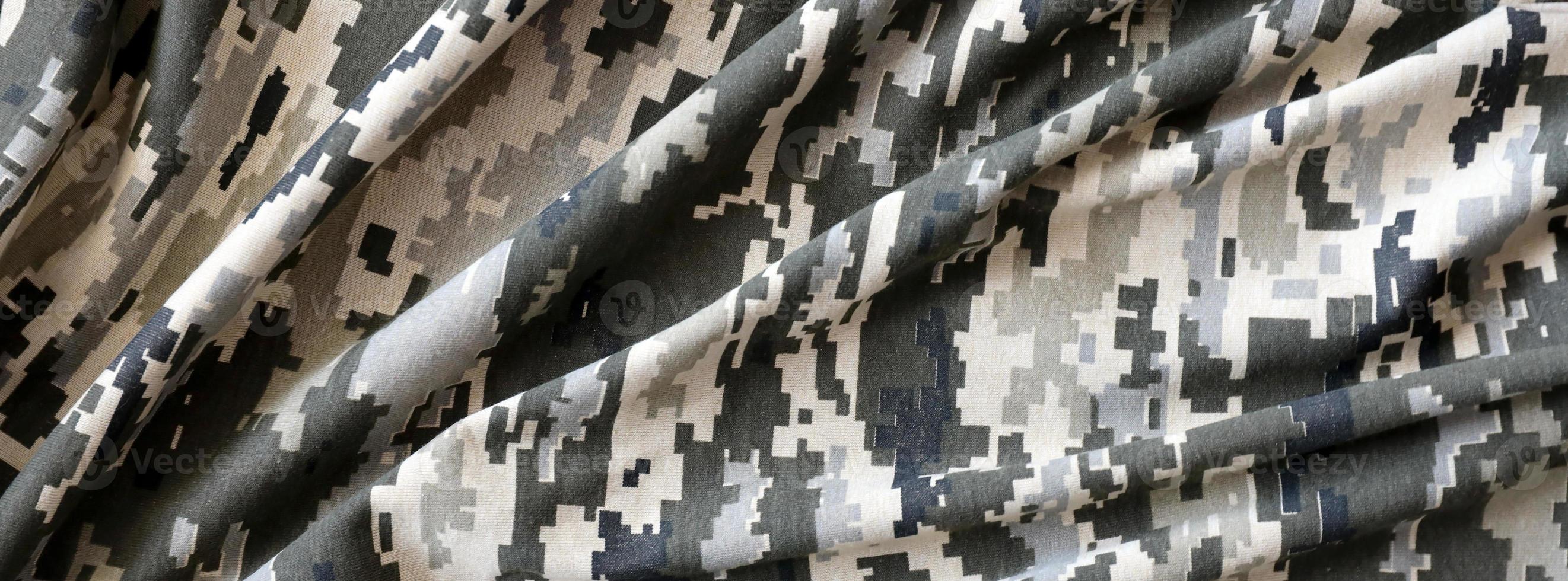 Fabric with texture of Ukrainian military pixeled camouflage. Cloth with camo pattern in grey, brown and green pixel shapes. Official uniform of Ukrainian soldiers photo