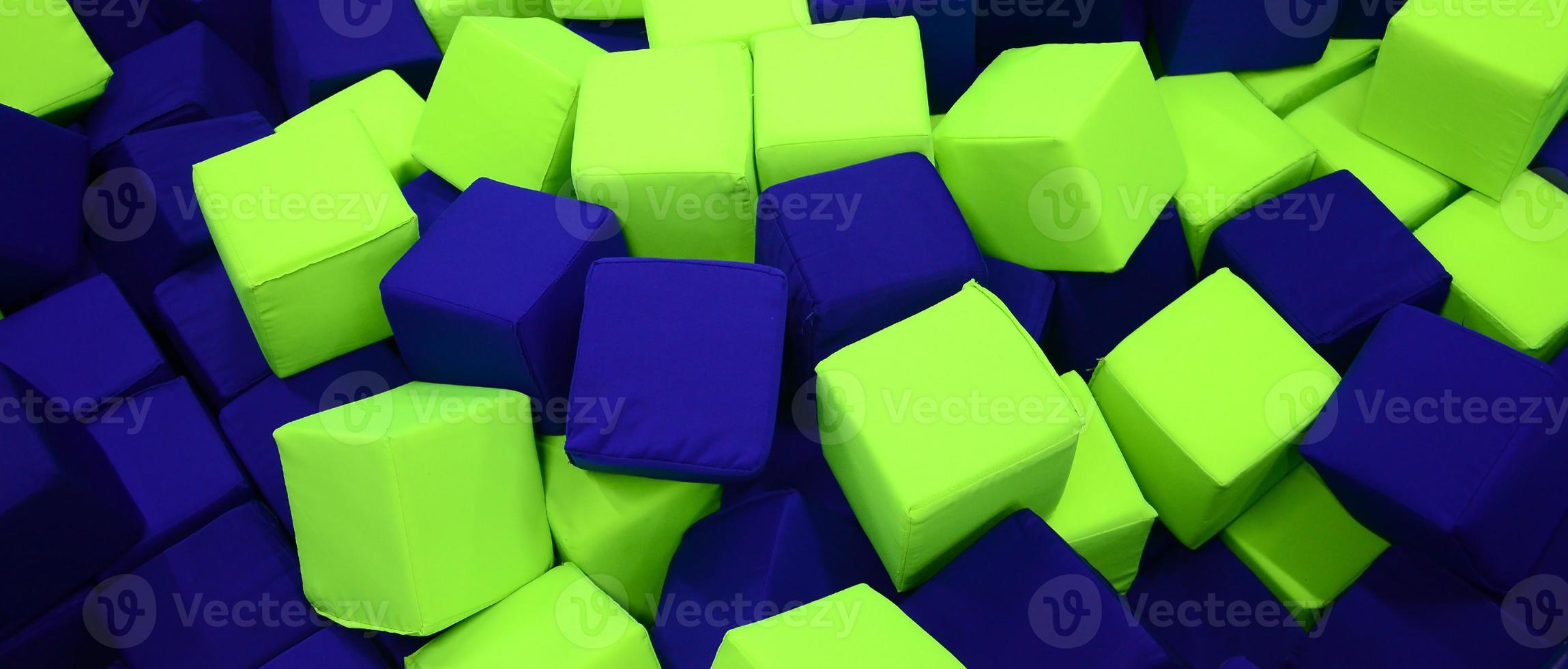 Many colorful soft blocks in a kids' ballpit at a playground photo