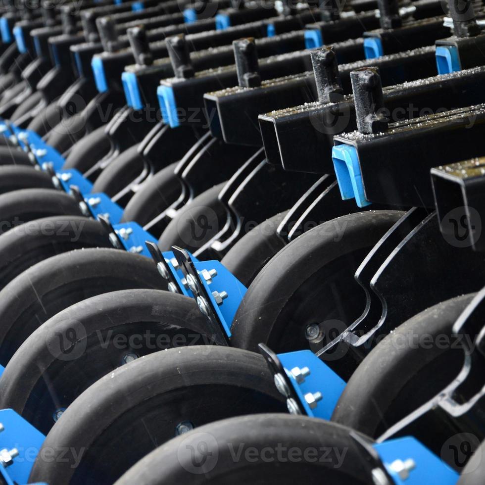 Row of wheels of the new industrial agricultural seeder close up photo