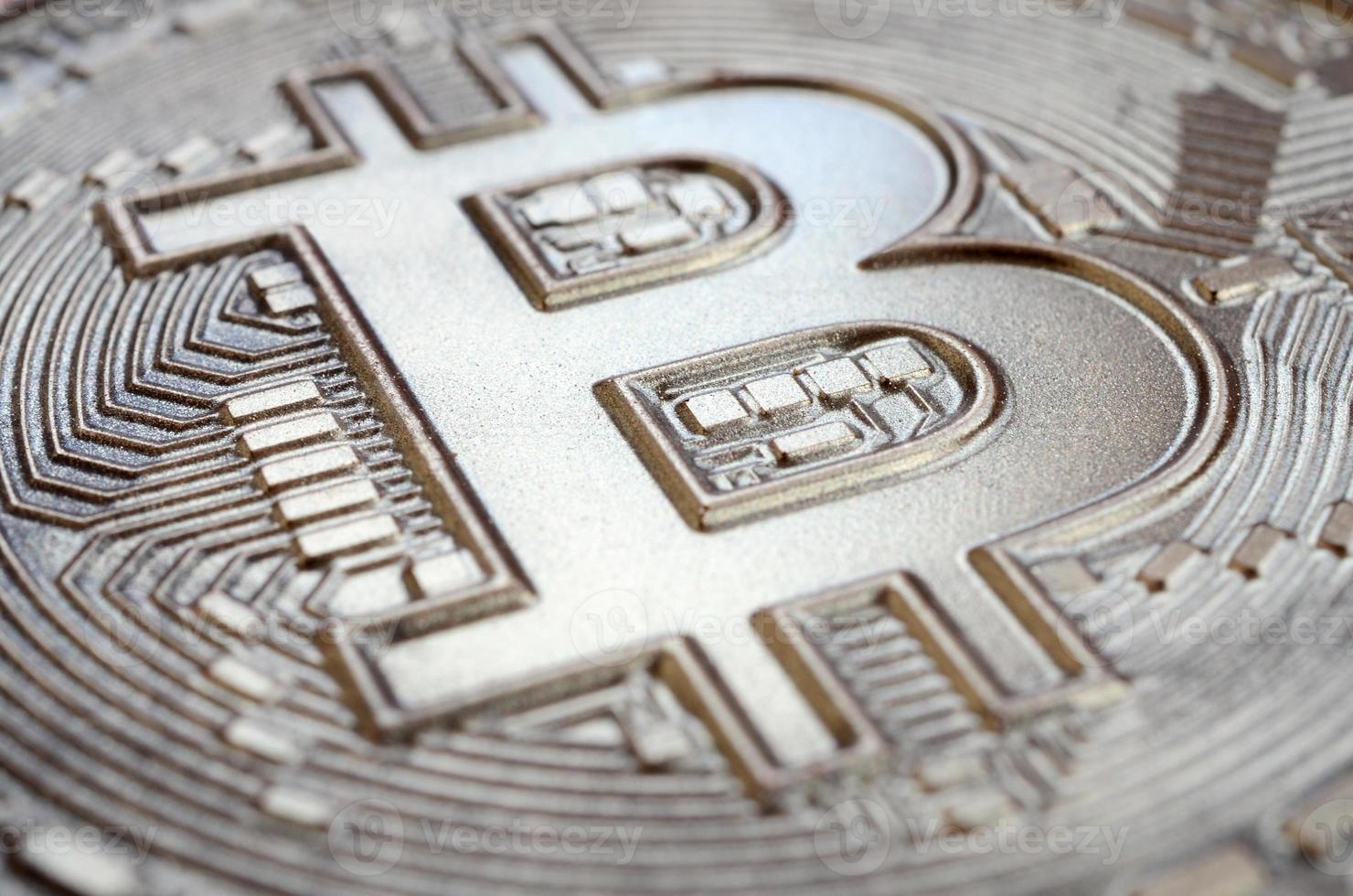 Close up shot of a physical bitcoin with a shiny relief surface made of chocolate. Abstract image of the crypto currency in an edible form photo