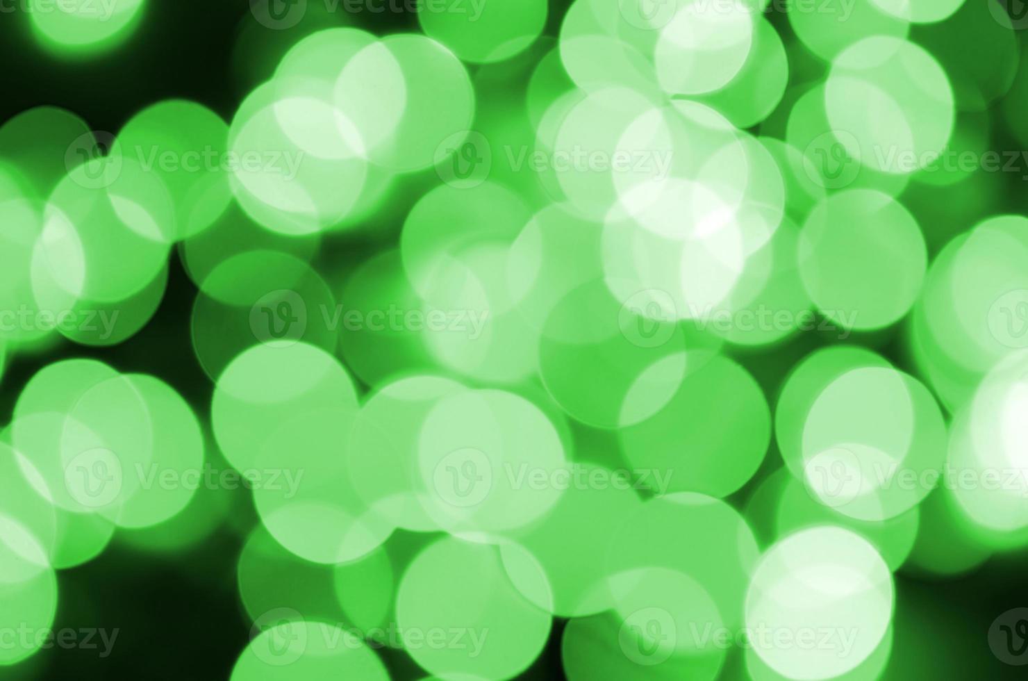 Green abstract Christmas blurred luminous background. Defocused artistic bokeh lights image photo