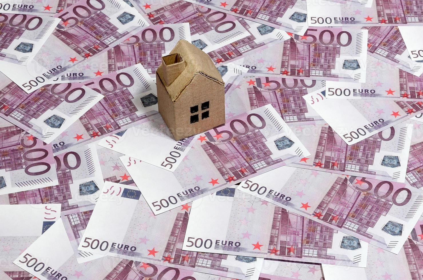 High Angle View Of A cardboard toy house On 500 Euro Notes. Money of euro for purchase of the private house. Mortgage concept photo