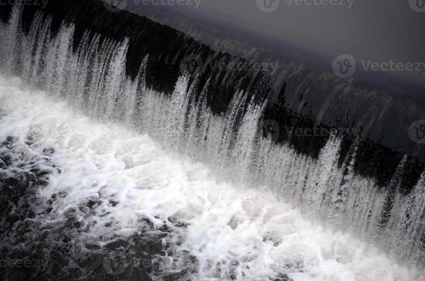 A picture of the flowing water. The dam is designed to regulate the water level in rivers within the city and to provide technical water to industrial objects photo