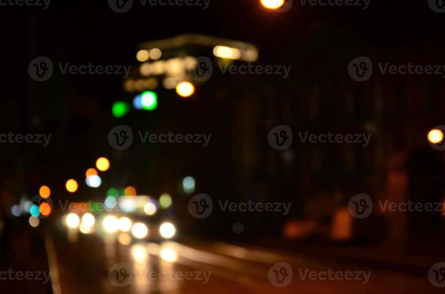 Blurred night scene of traffic on the roadway. Defocused image of cars traveling with luminous headlights. Bokeh Art photo