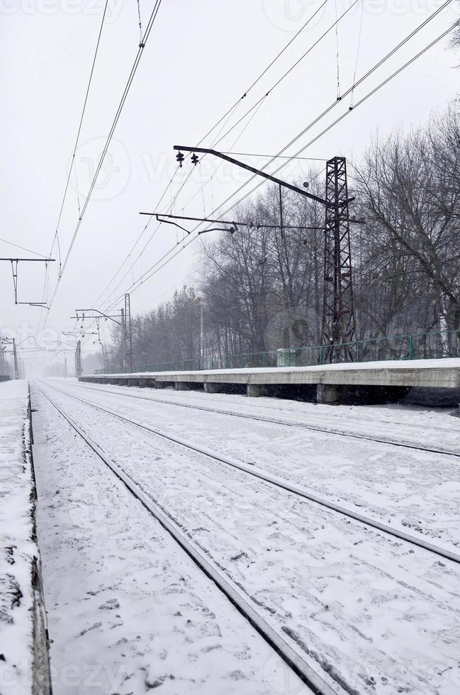 Railway station in the winter snowstorm photo