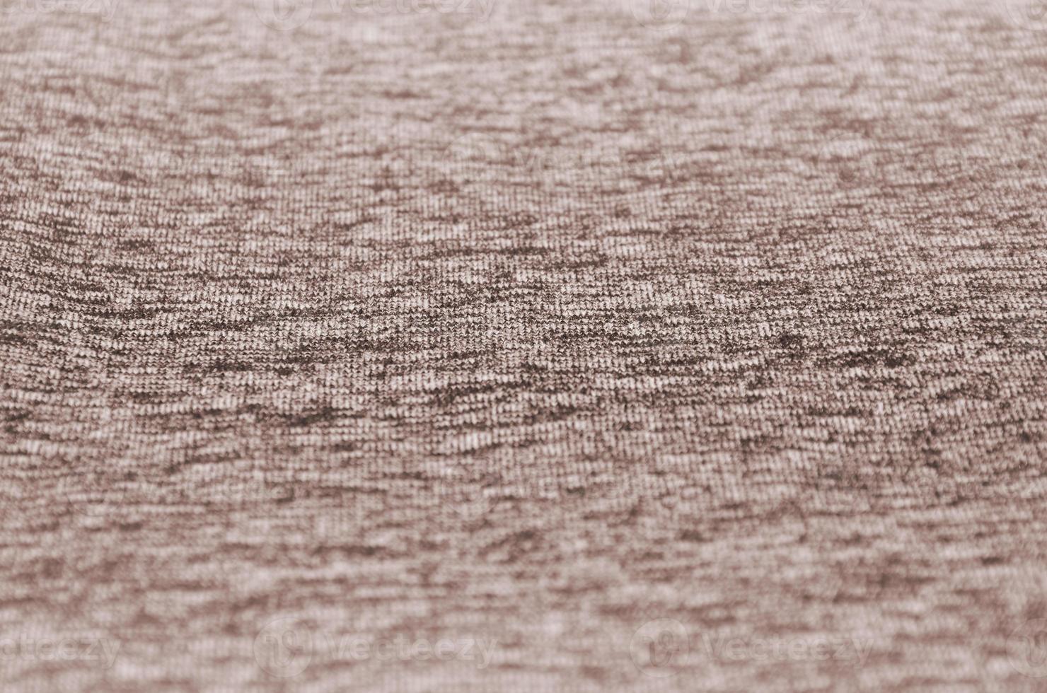 Real heather knitted fabric made of synthetic fibres textured background. Colored fabric texture. Background with delicate striped pattern photo