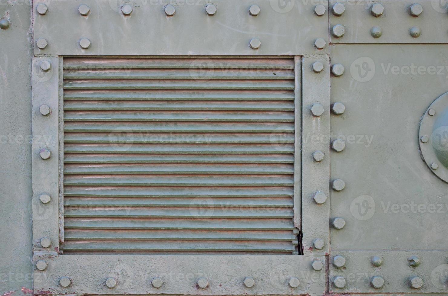 The texture of the wall of the tank, made of metal and reinforced with a multitude of bolts and rivets. Images of the covering of a combat vehicle from the Second World War photo