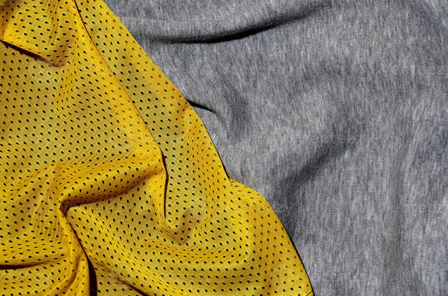 Top view of cloth textile surface. Close-up rumpled heater and knitted fabric texture with a thin striped pattern. Sport clothing fabric texture. Colored basketball shirt and heater hoodie photo