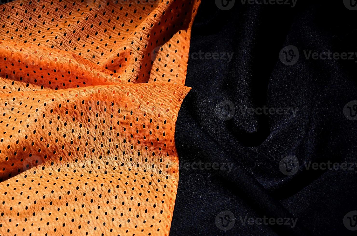 Sport clothing fabric texture background, top view of orange cloth textile surface photo