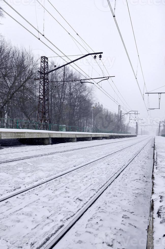 Railway station in the winter snowstorm photo
