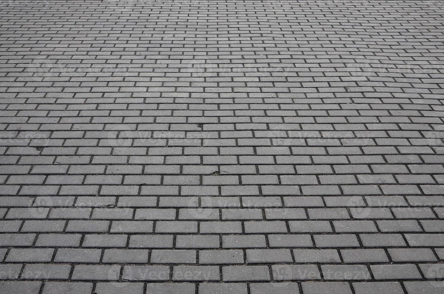 Photo of the site from the old paving slab with small defects and cracks
