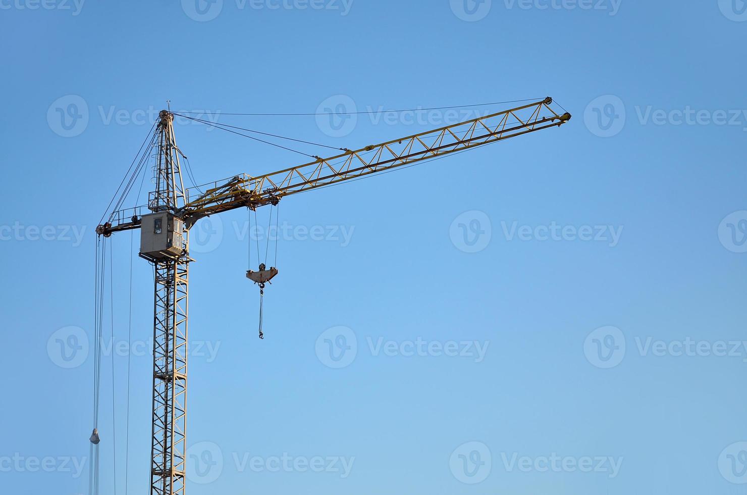 Tower crane against a blue sky photo