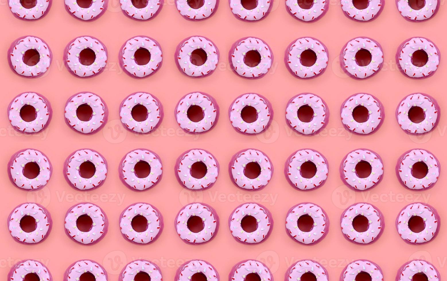 Many small plastic donuts lies on a pastel colorful background. Flat lay minimal pattern. Top view photo
