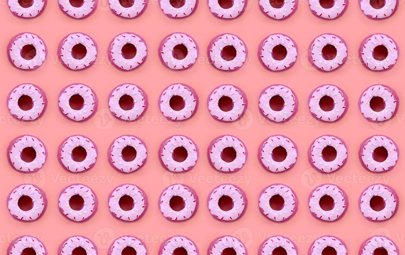 Many small plastic donuts lies on a pastel colorful background. Flat lay minimal pattern. Top view photo