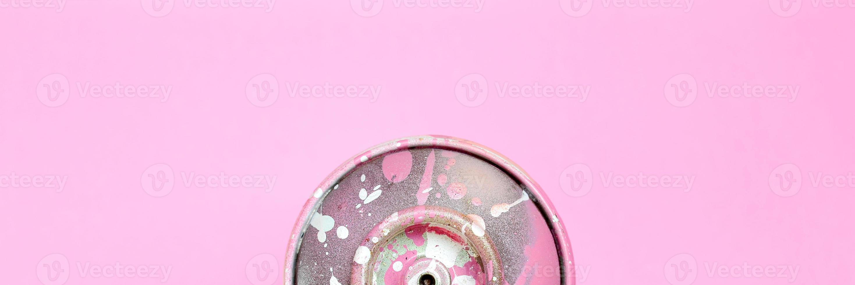 Single used spray can for graffiti drawing lies on a pastel colored backgroung. Street art painting concept. Minimal flat lay. Top view photo