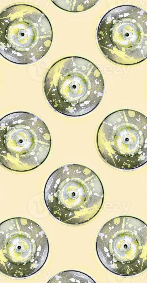 Many used spray cans for graffiti drawing lies on a pastel colored backgroung. Street art painting concept. Minimal flat lay pattern. Top view photo