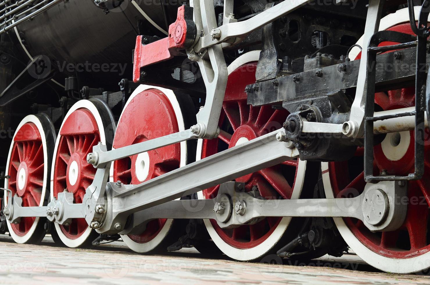 Red wheels of steam train photo