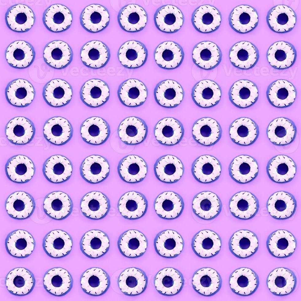 Many small plastic donuts lies on a pastel colorful background. Flat lay minimal pattern. Top view photo