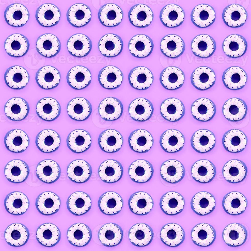 Many small plastic donuts lies on a pastel colorful background. Flat lay minimal pattern. Top view photo