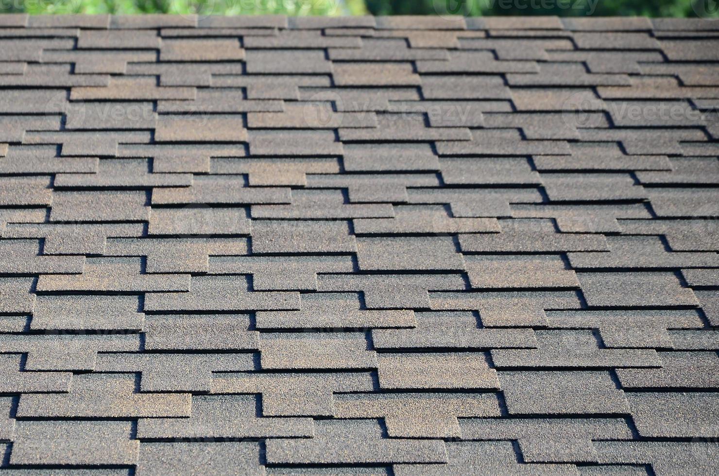 Modern roofing and decoration of chimneys. Flexible bitumen or slate shingles photo