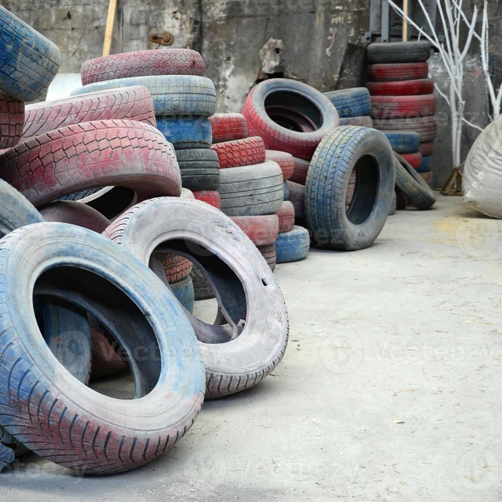 A picture of many old used tires left on a waste dump photo