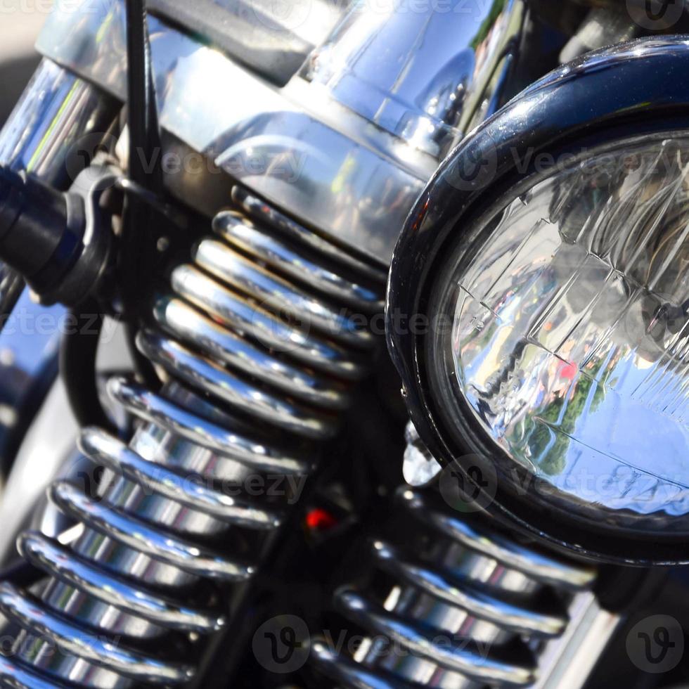 Fragment of chromed shiny lamp of old classic motorbike photo