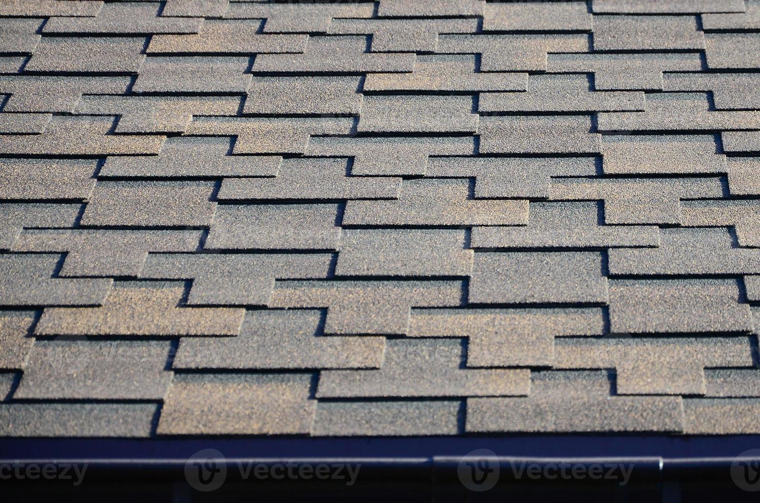 Modern roofing and decoration of chimneys. Flexible bitumen or slate shingles photo