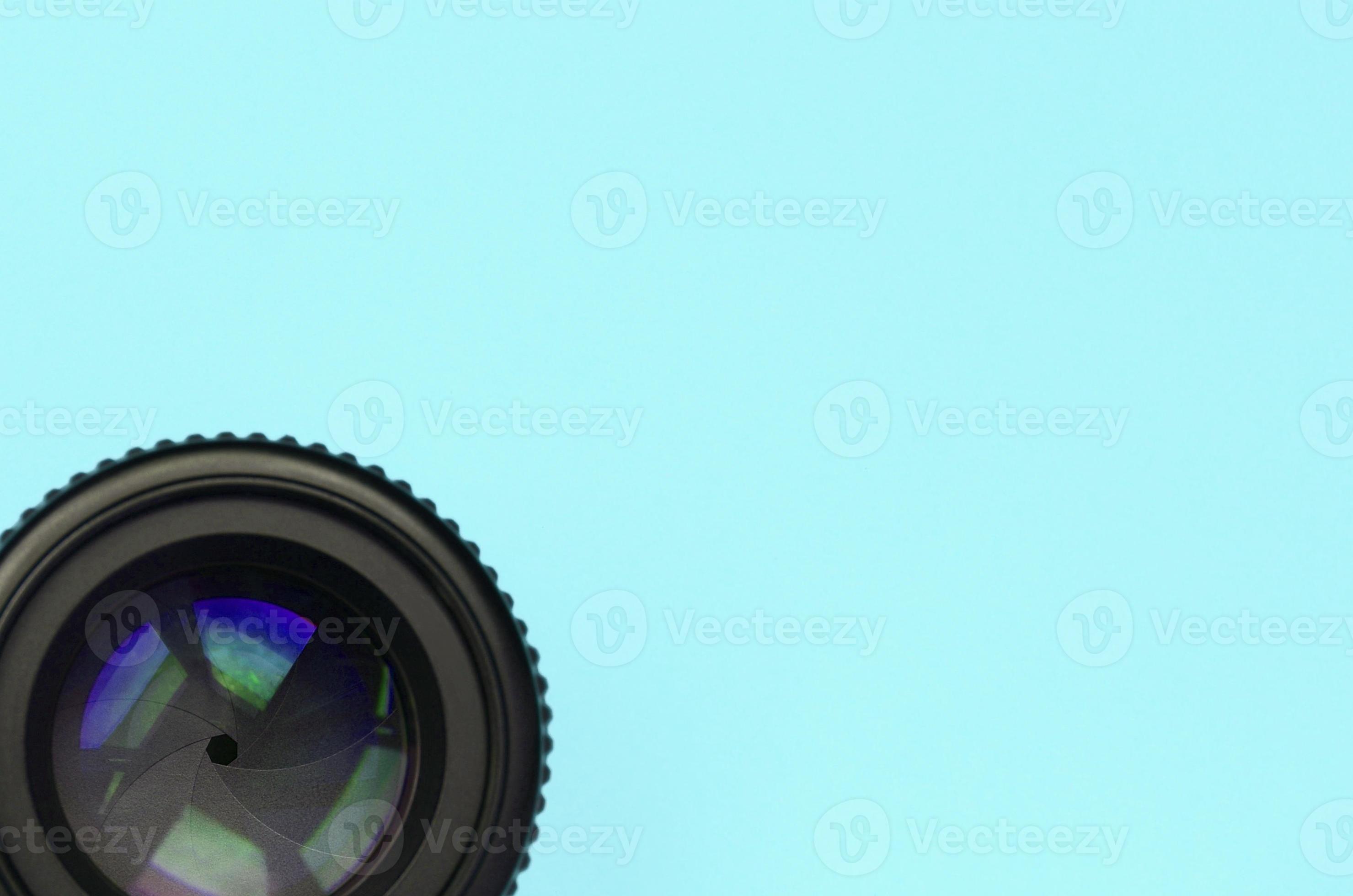 Camera lens with a closed aperture lie on texture background of fashion