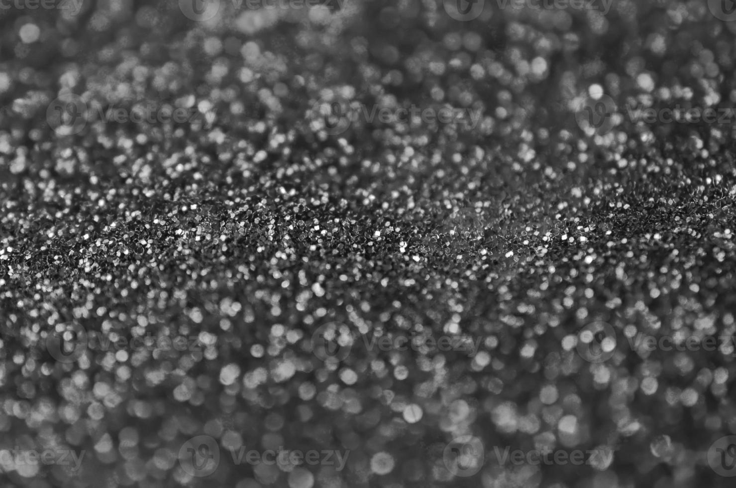 Silver decorative sequins. Background image with shiny bokeh lights from small elements photo