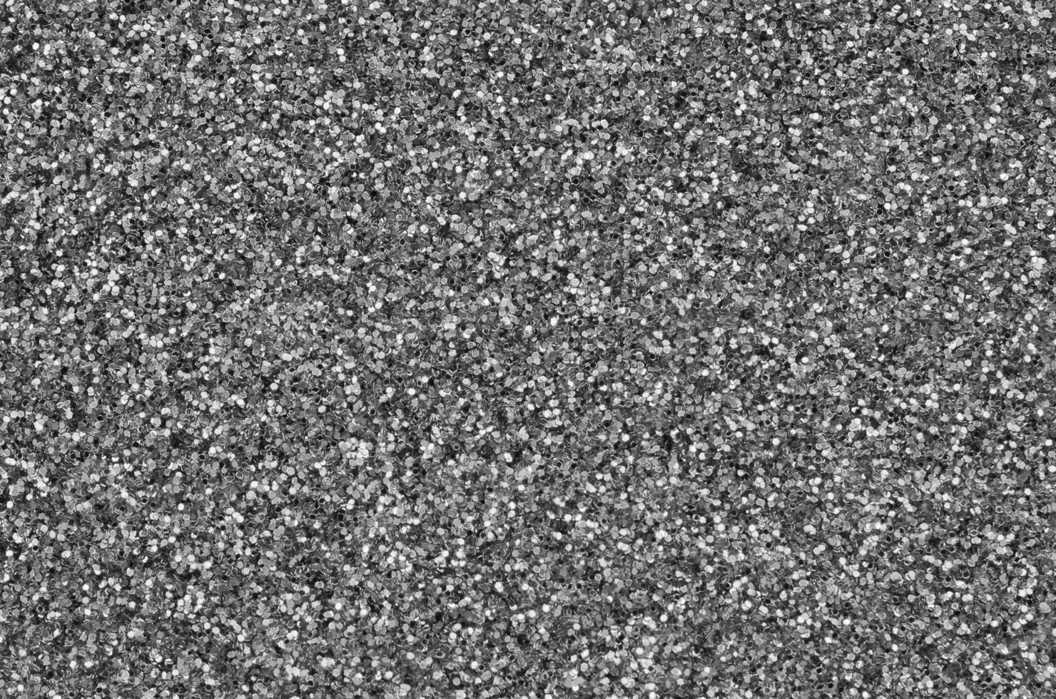 Silver decorative sequins. Background image with shiny bokeh lights from small elements photo
