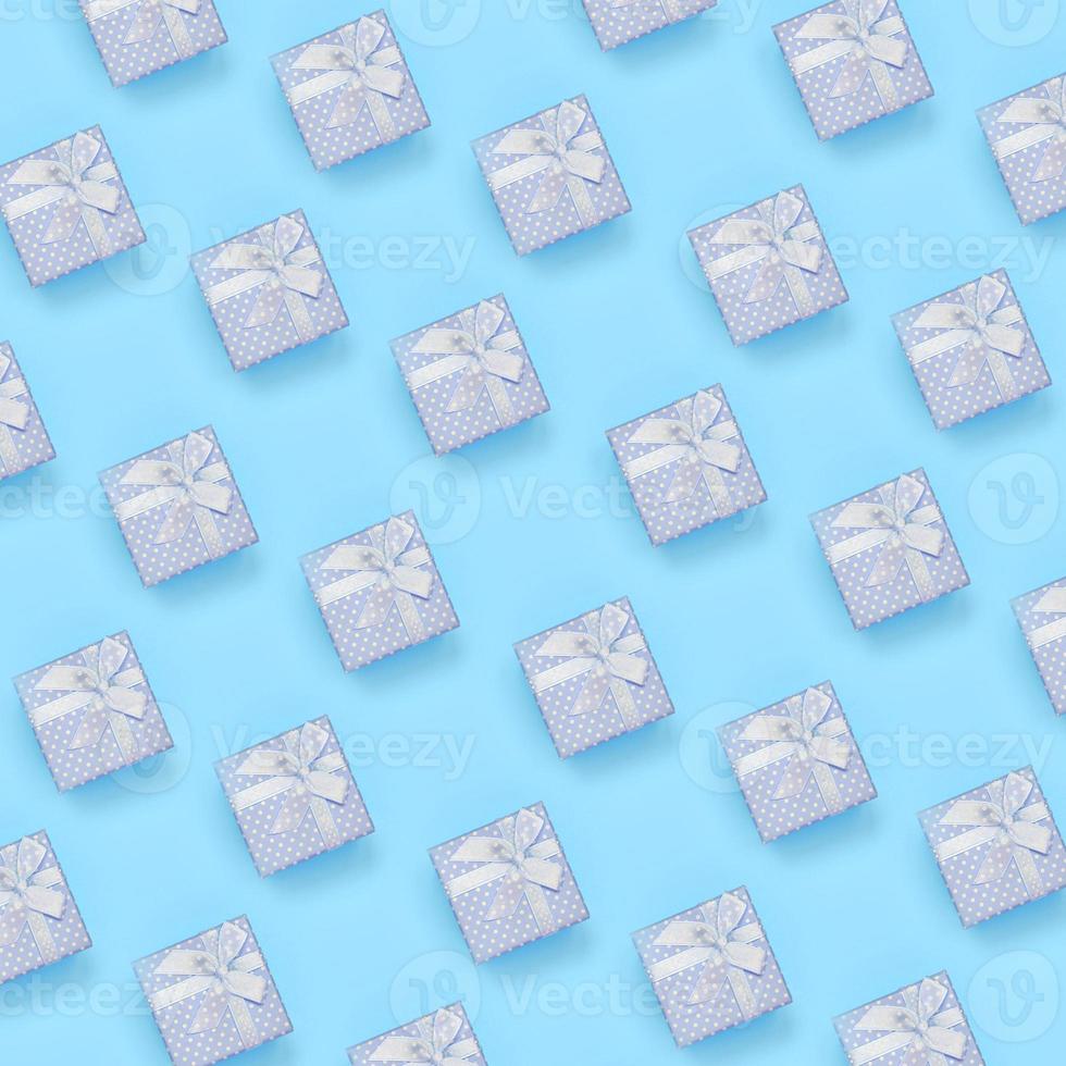 A lot of blue gift boxes lies on texture background of fashion pastel blue color paper in minimal concept photo