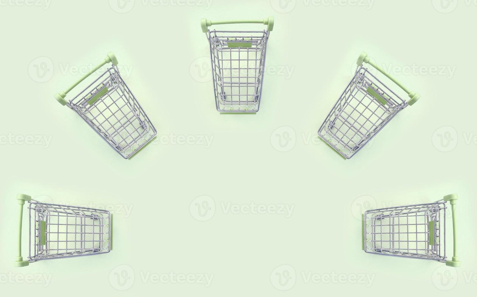 Pattern of many small shopping carts on a lime background photo