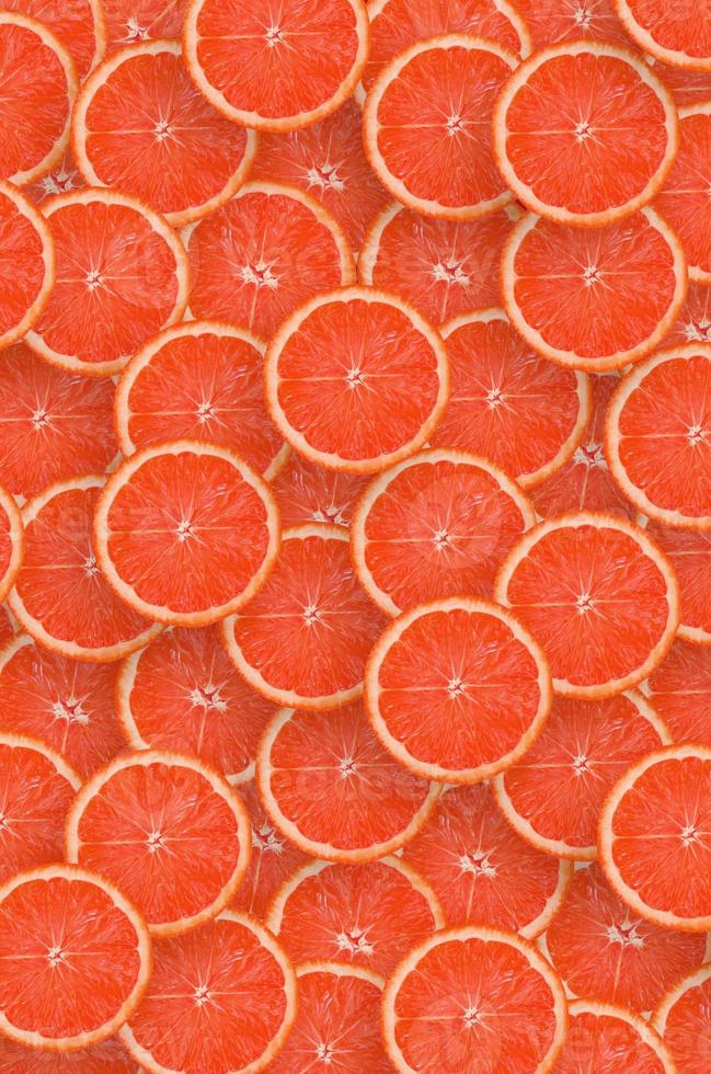 Pattern of red grapefruit citrus slices. Citrus flat lay photo