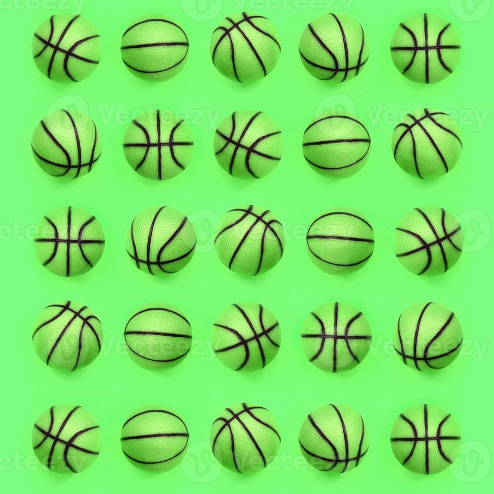 Many small green balls for basketball sport game lies on texture background photo