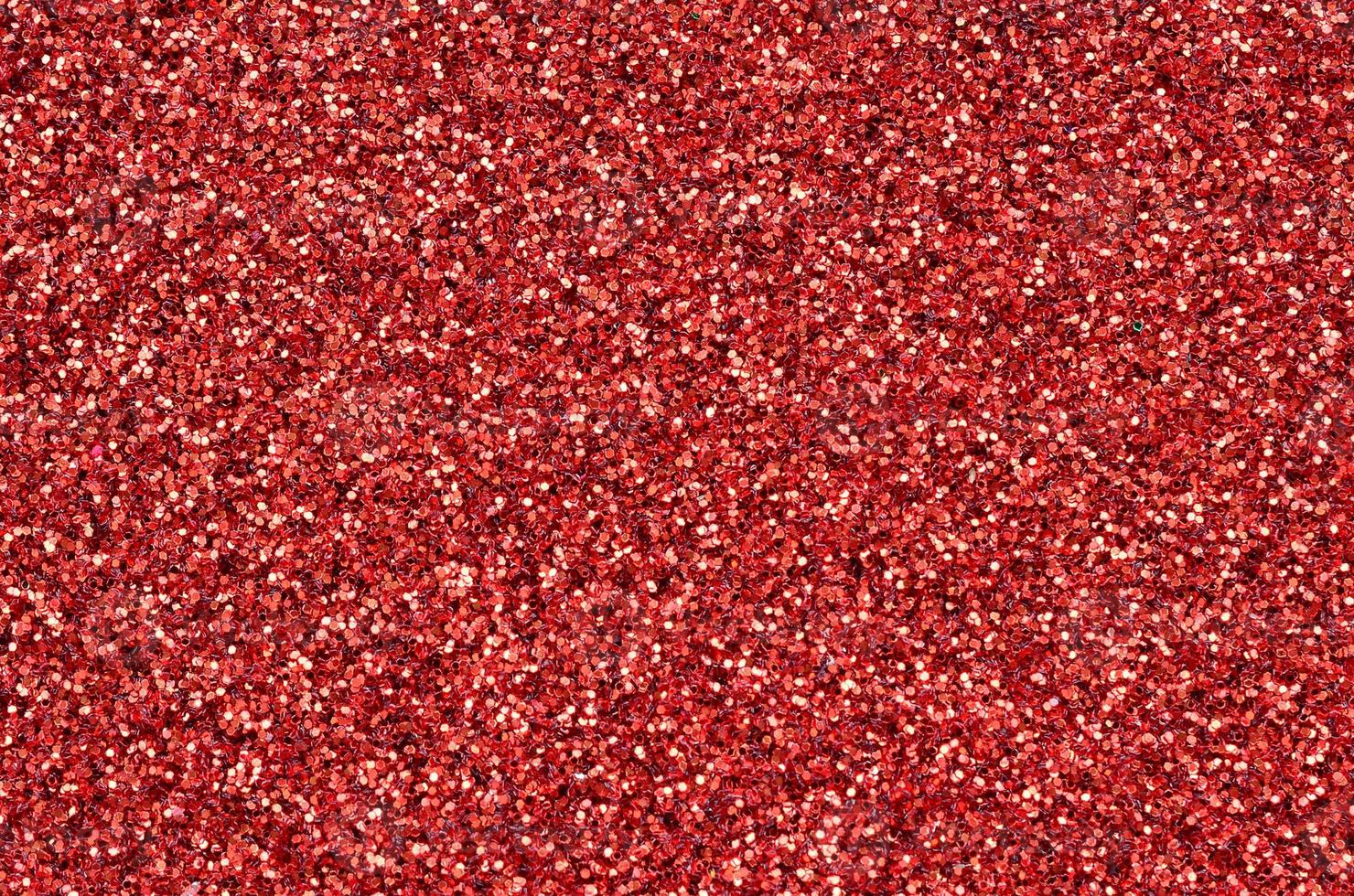 Crimson red decorative sequins. Background image with shiny bokeh lights from small elements photo