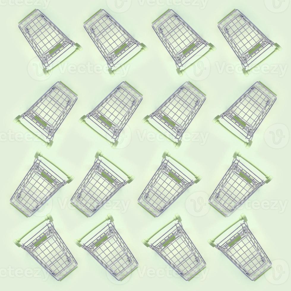 Pattern of many small shopping carts on a lime background photo