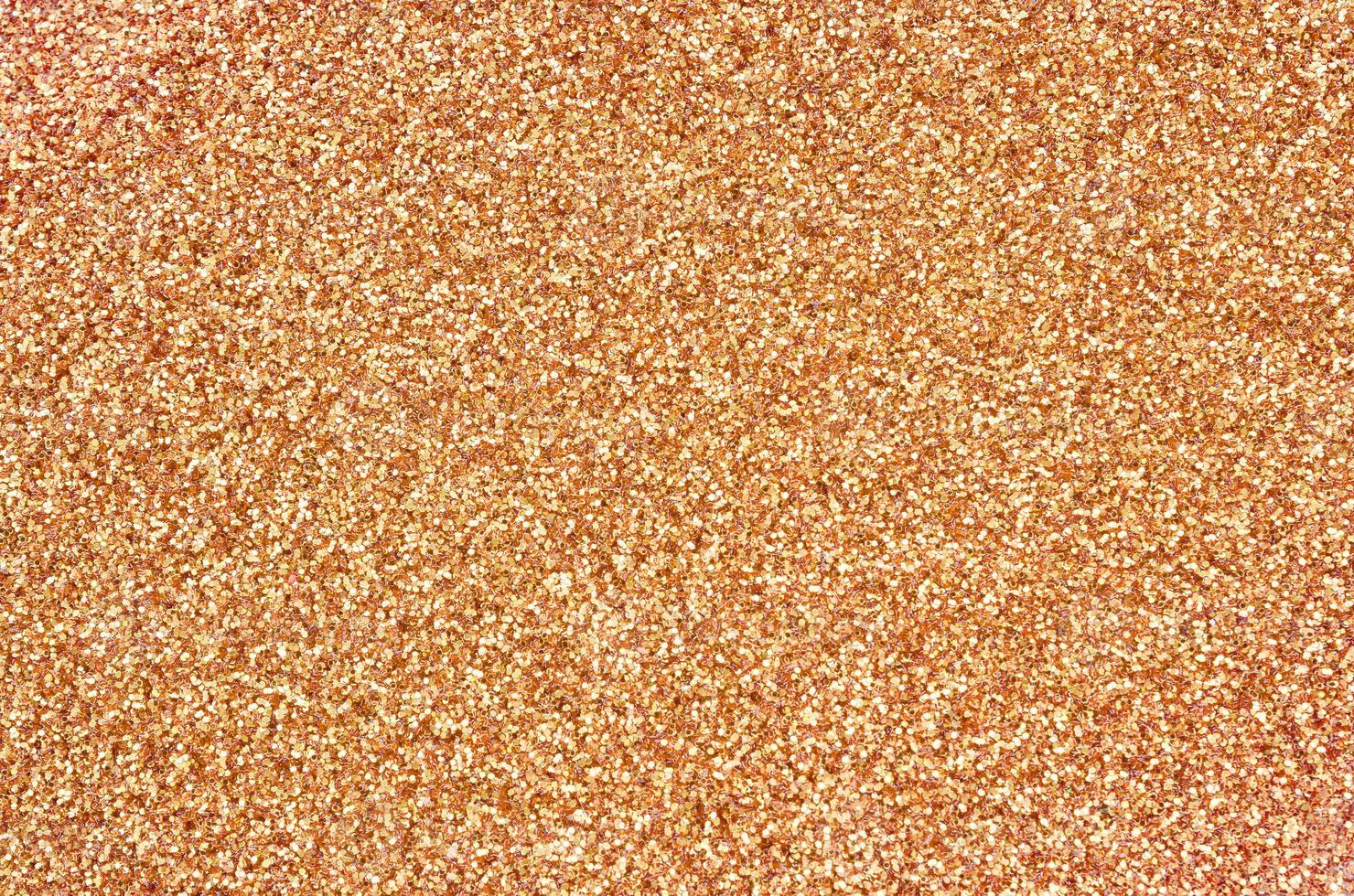 Orange decorative sequins. Background image with shiny bokeh lights from small elements photo