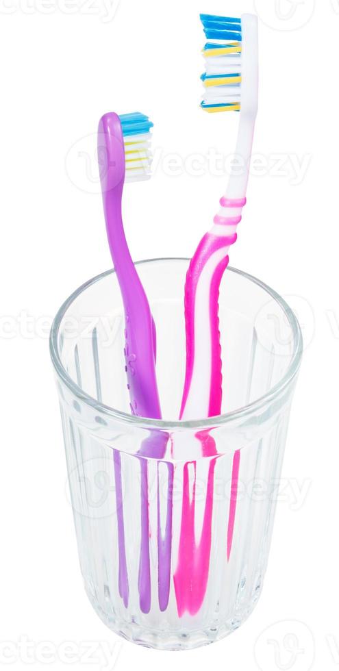 adult and children tooth brushes in glass photo