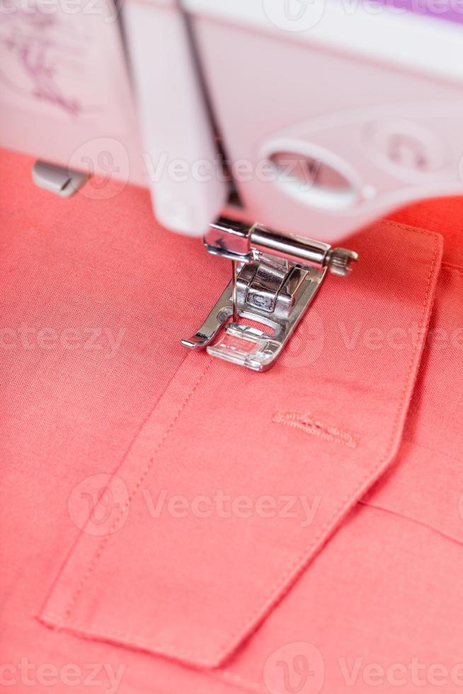 attaching pocket to red shirt on sewing machine photo