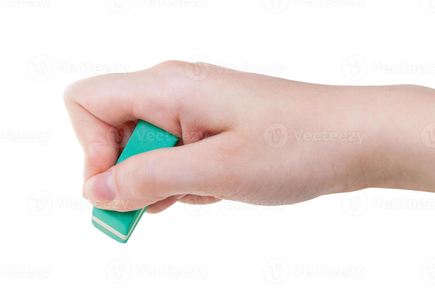 hand with green rubber eraser close up isolated photo