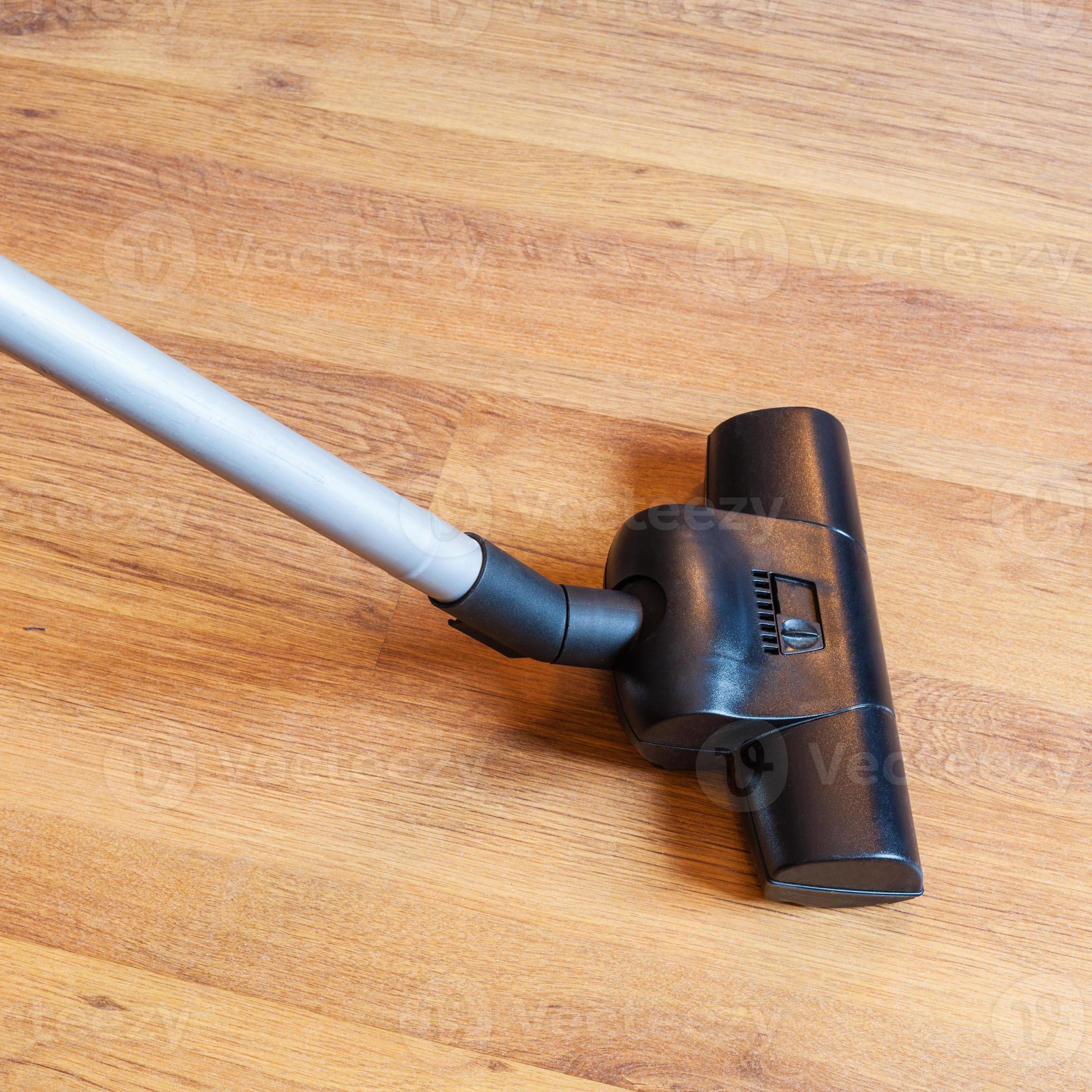 cleaning of parquet floor by vacuum cleaner 12586066 Stock Photo at Vecteezy
