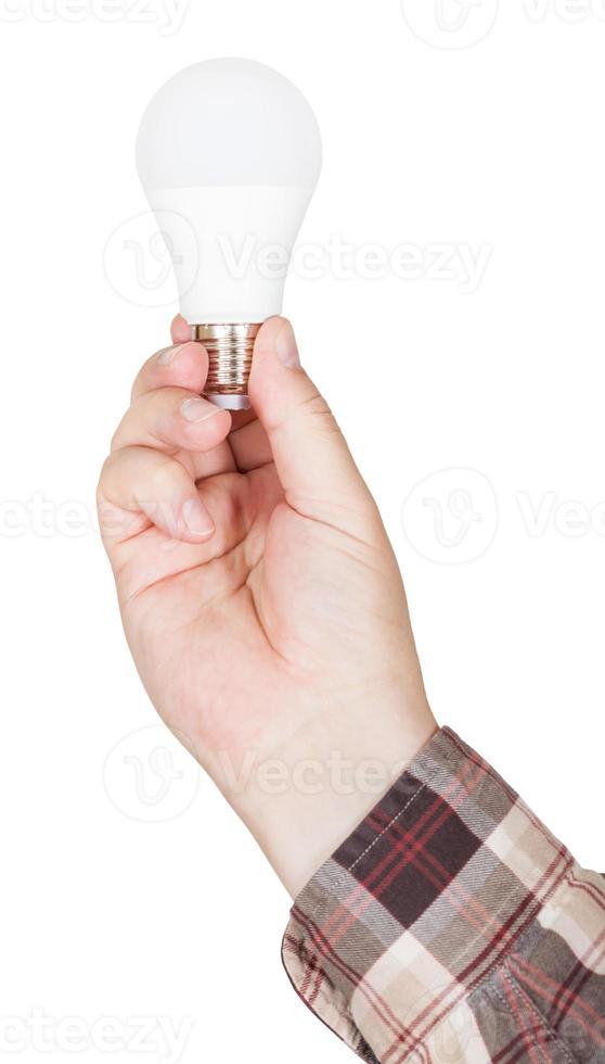 male hand holds compact LED lamp isolated photo