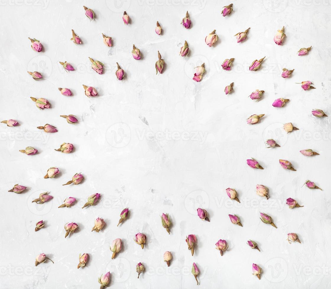 frame from rose flower buds on gray concrete plank photo