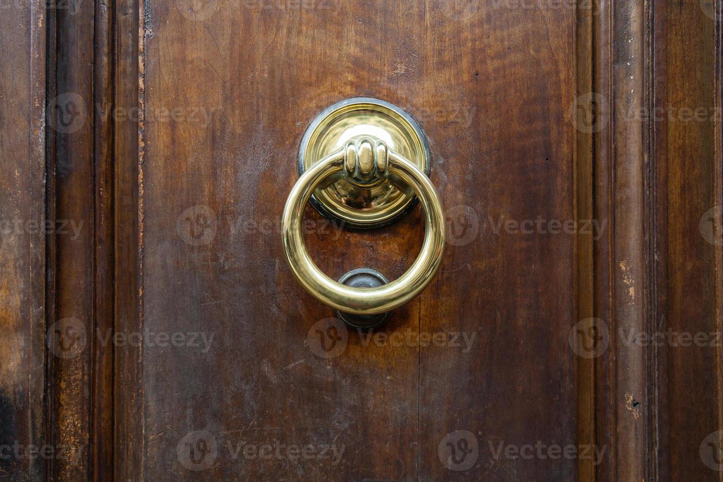 brass ring knocker on old wooden door in Florence photo