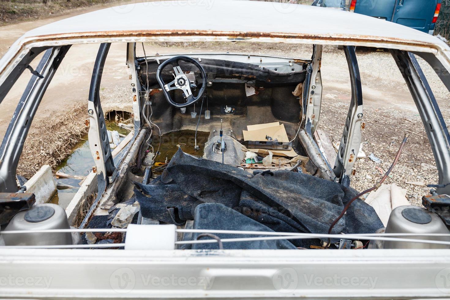 disassembled car at an automobile junkyard photo