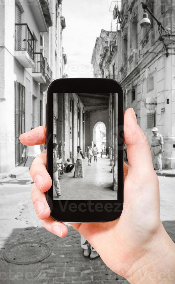 tourist taking photo of arcades in Havana city