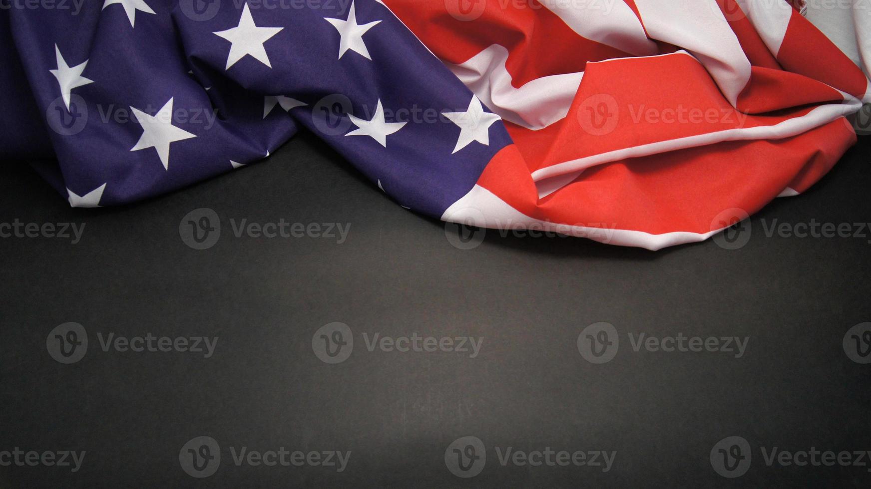 Rumpled Flag of United States of America on grey background photo