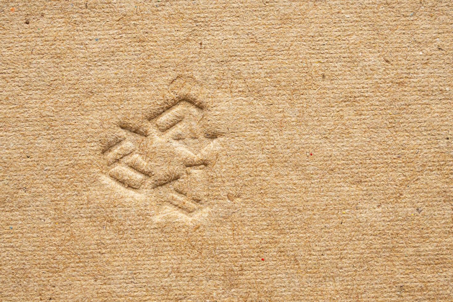 recycle sign on brown cardboard paper texture background photo