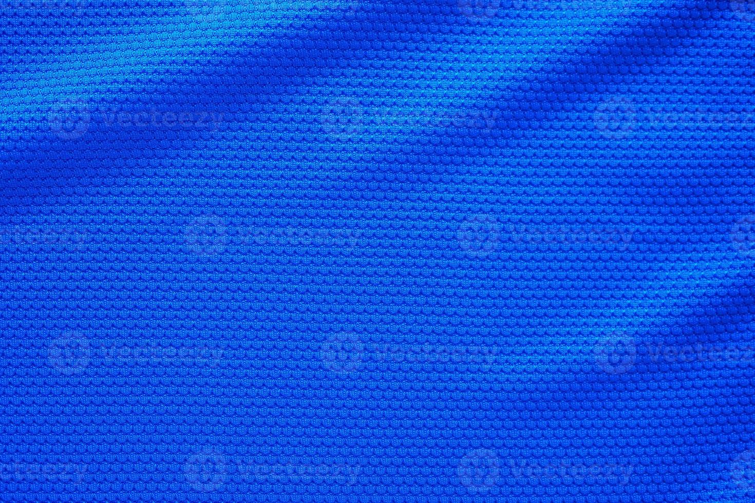 Blue football jersey clothing fabric texture sports wear background, close up top view photo