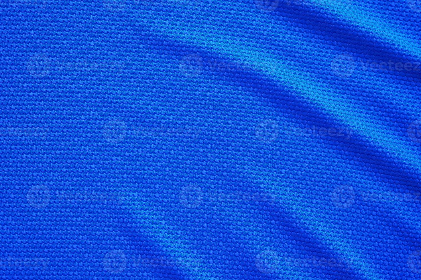 Blue football jersey clothing fabric texture sports wear background, close up top view photo